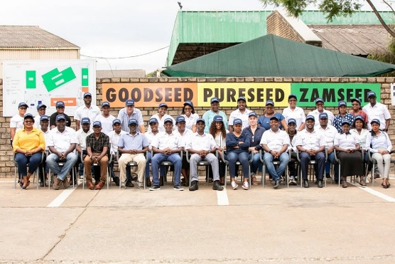 The Zamseed team photographed together at the Goodseed, Pureseed, Zamseed wall